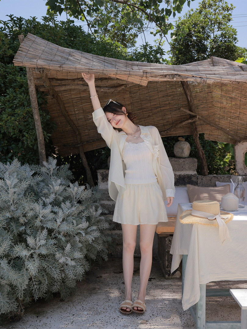 Woman wearing a cream summer outfit outdoors