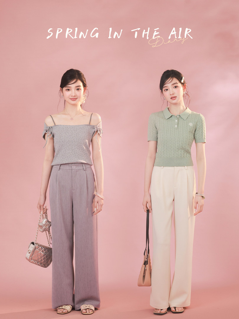 Two women modeling spring outfits on a pink background