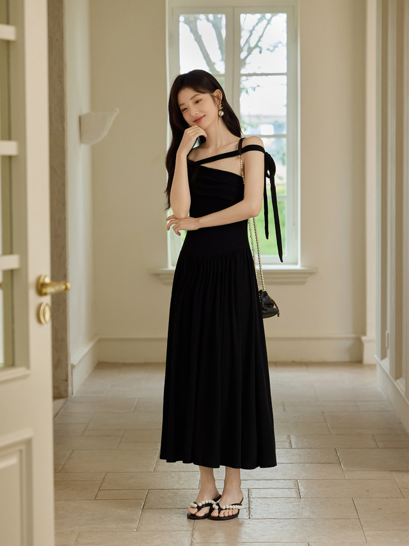 Black off-shoulder maxi dress worn by a model indoors