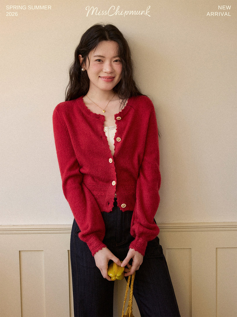 Model wearing a red buttoned cardigan with a scalloped neckline