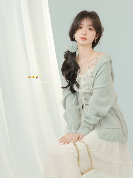 Pastel cardigan and floral dress worn by a female model