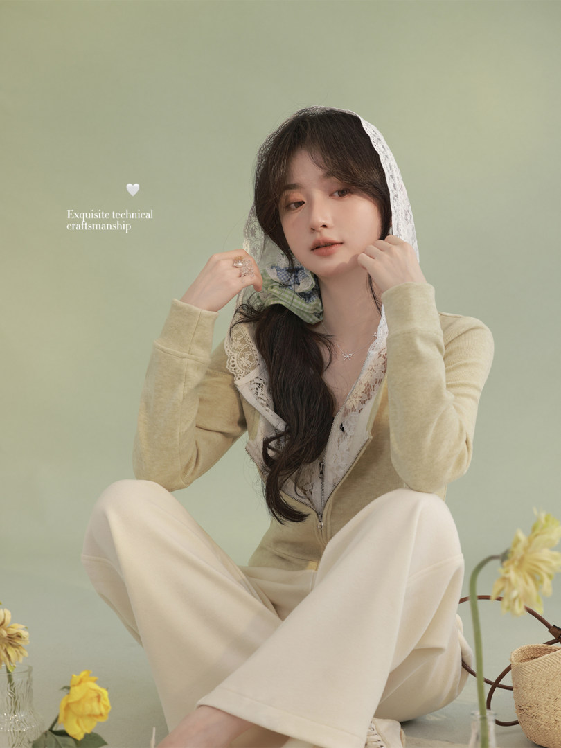 Model wearing a light beige lace-trim hooded loungewear set