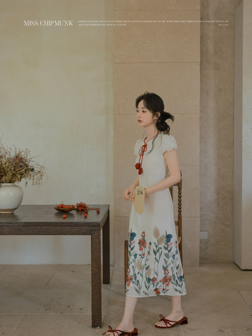 Woman wearing a white floral midi dress with short sleeves