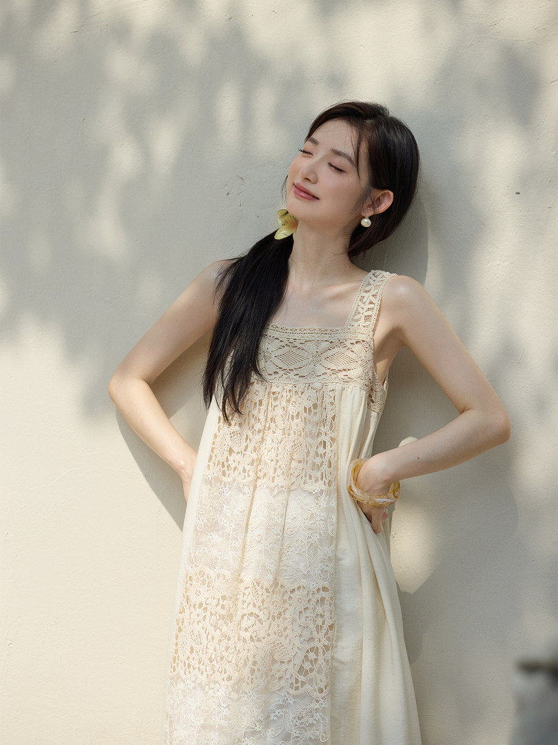 Model wearing a cream lace sleeveless dress