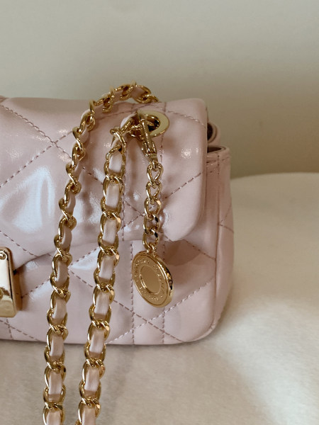 Pink quilted handbag with gold chain strap and hardware