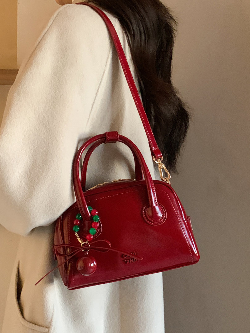 Red mini handbag worn over the shoulder on a model