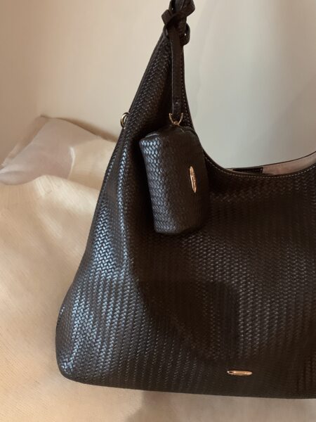Black woven handbag with matching pouch on a light background