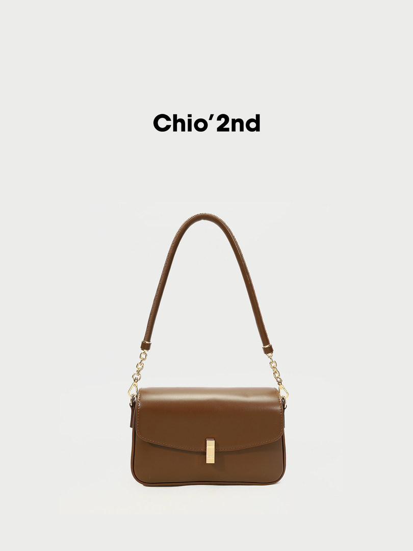 Brown leather shoulder handbag with gold hardware on a white background