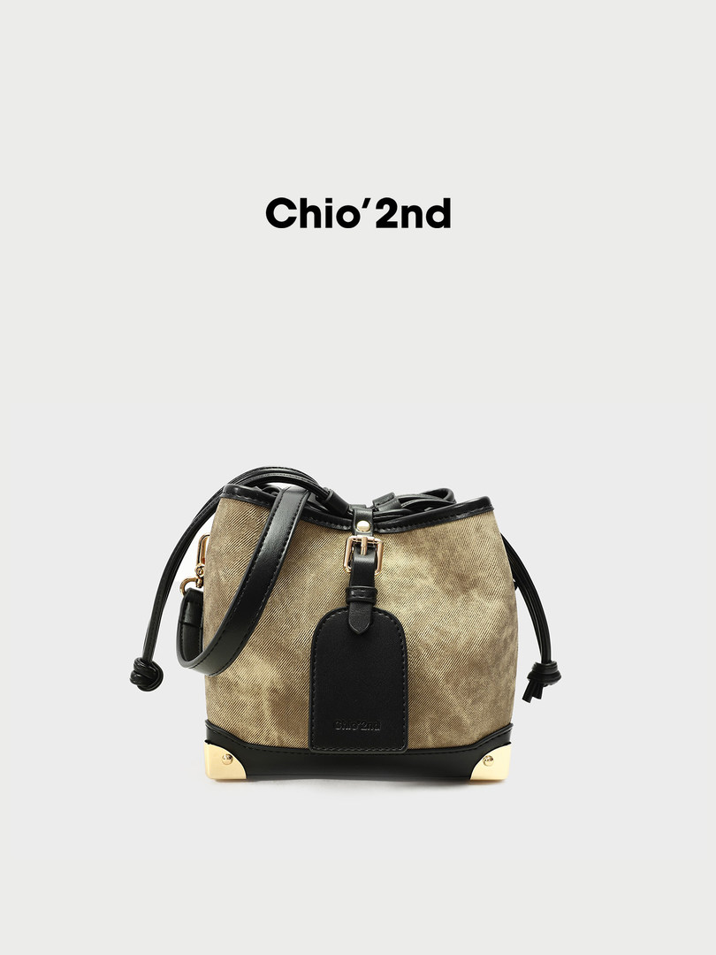 Beige and black bucket-style handbag with shoulder strap