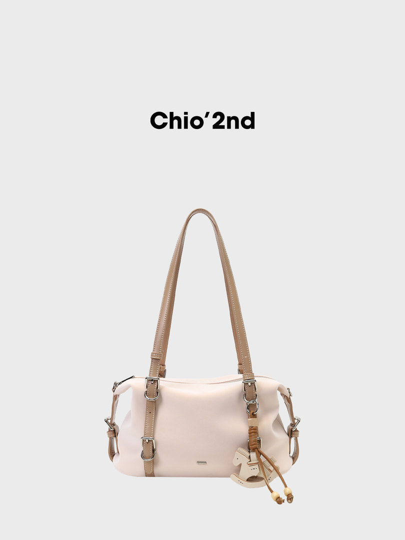 Light beige shoulder handbag with long straps on a plain background