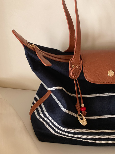 Navy and tan striped tote handbag with leather straps