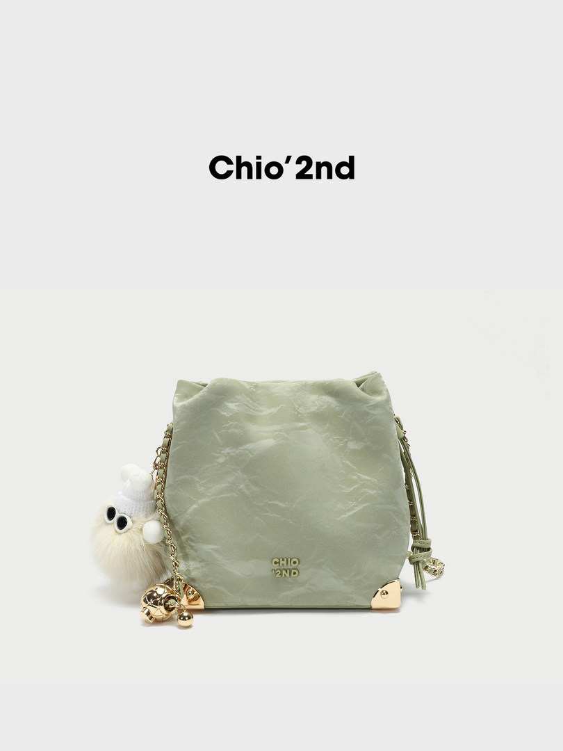 Light green shoulder bag with charm accessory
