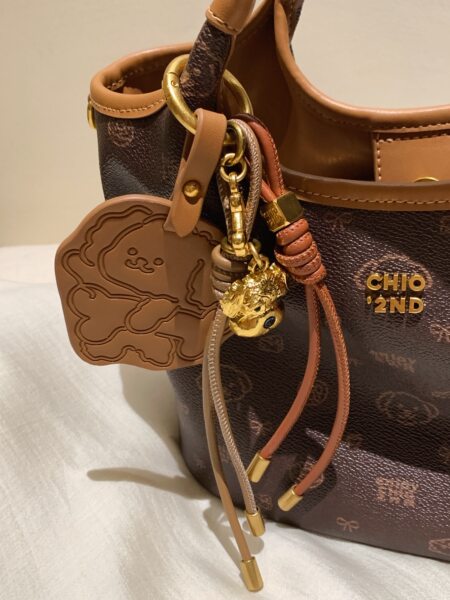 Brown leather handbag with gold charms and logo detail
