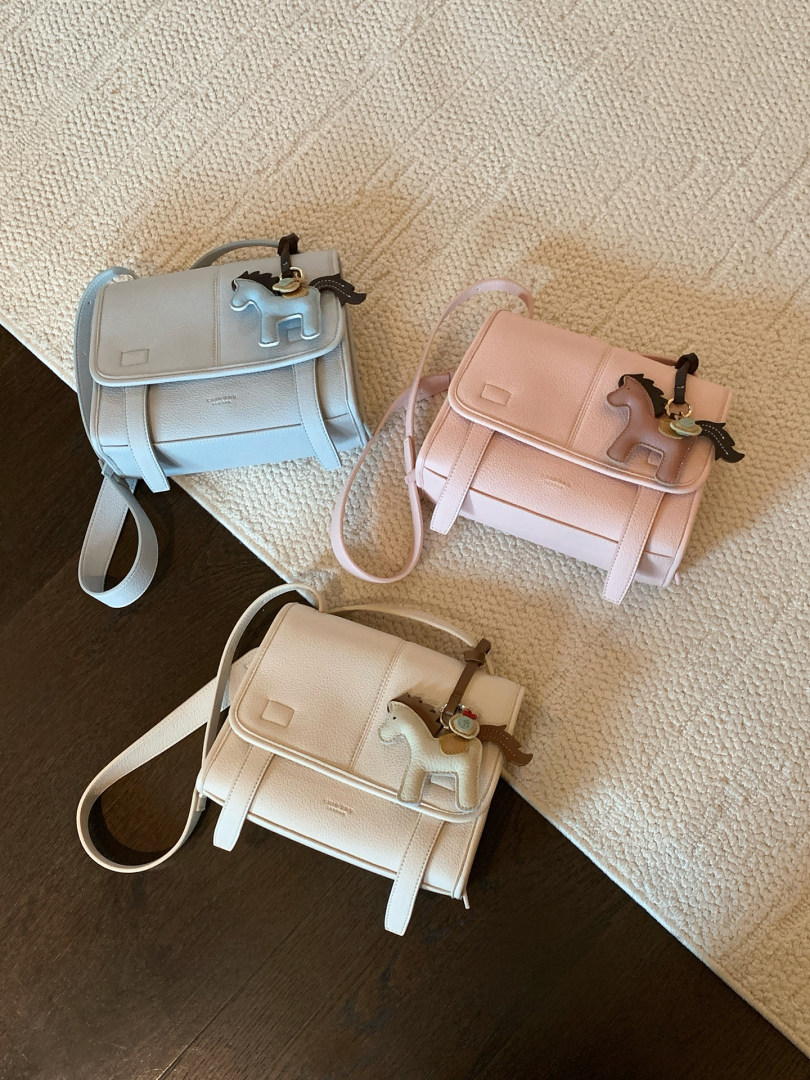 Three pastel structured mini handbags with shoulder straps and horse charms