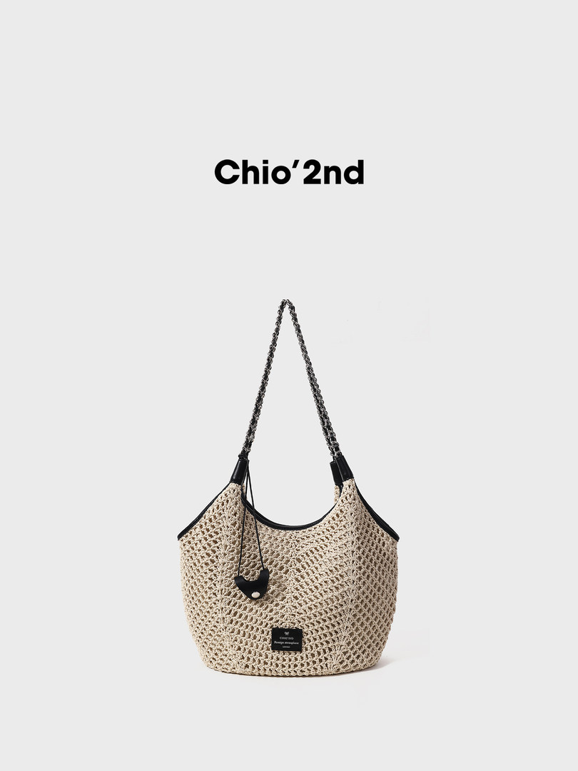 Beige woven tote handbag with chain strap on a white background