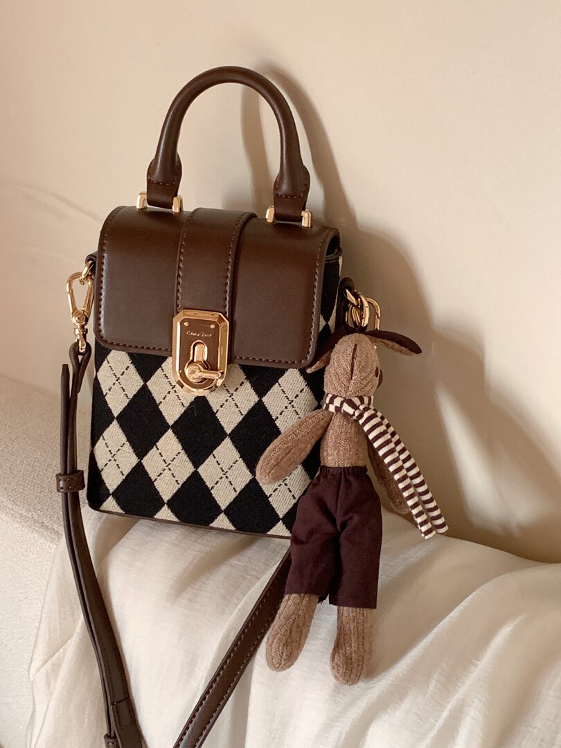 Brown leather handbag with argyle panel and teddy bear charm