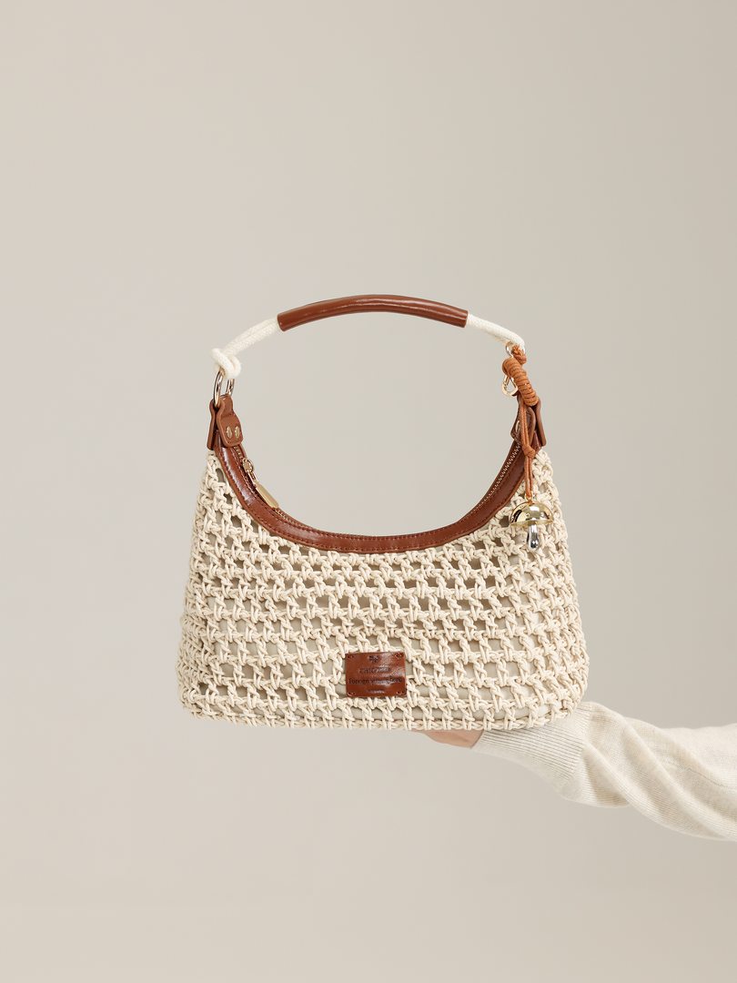 Cream woven handbag with brown leather trim and handle