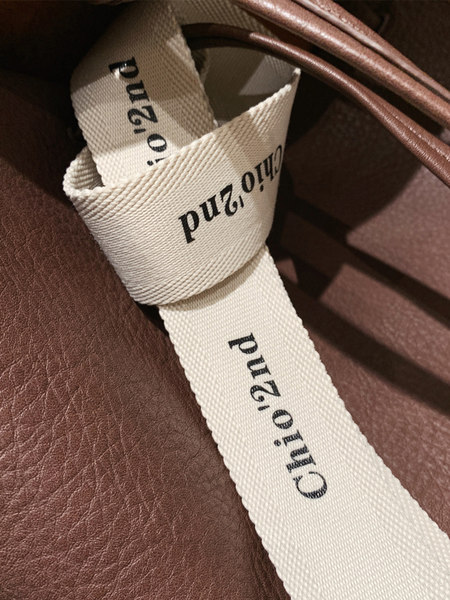 Close-up of a brown leather Chloé bag strap with logo