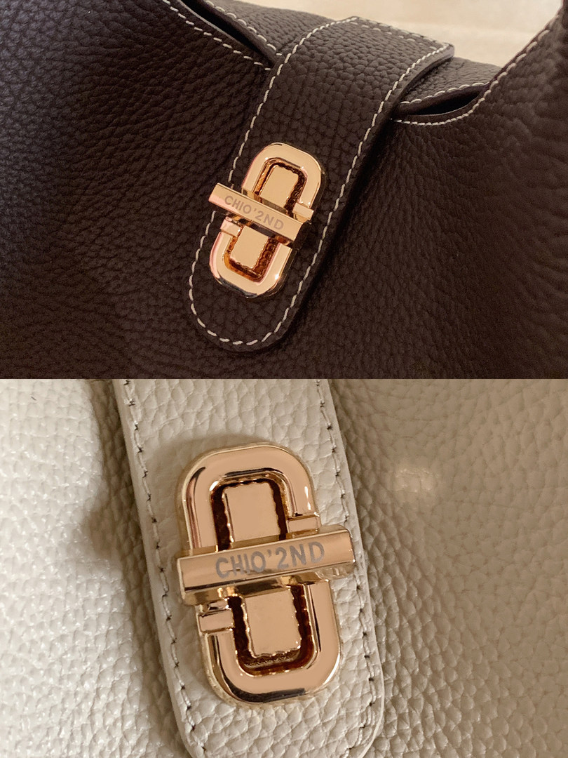 Close-up of a textured leather handbag with gold hardware in brown and cream colors