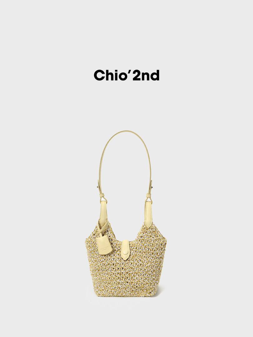 Straw woven shoulder bag with a long handle on a white background