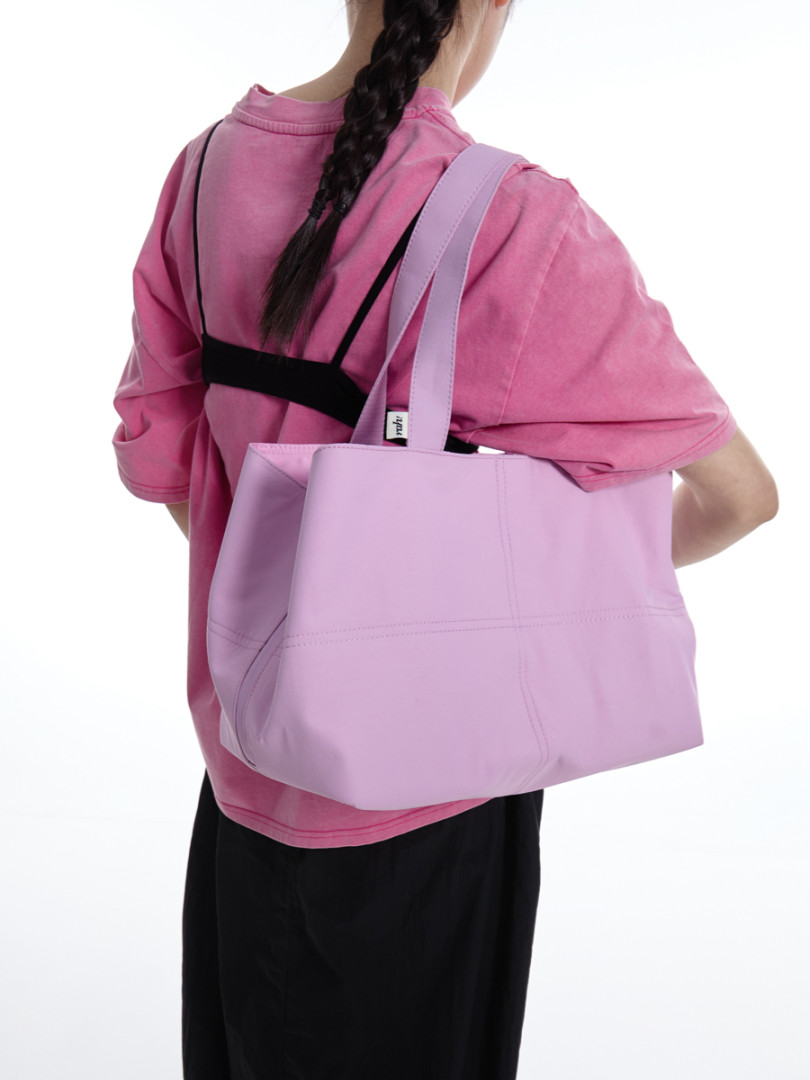 Lavender tote bag worn over the shoulder on a model