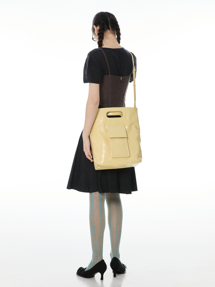 Model wearing a yellow shoulder bag