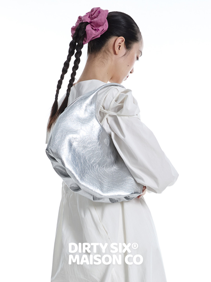 Silver metallic backpack worn on a model's back