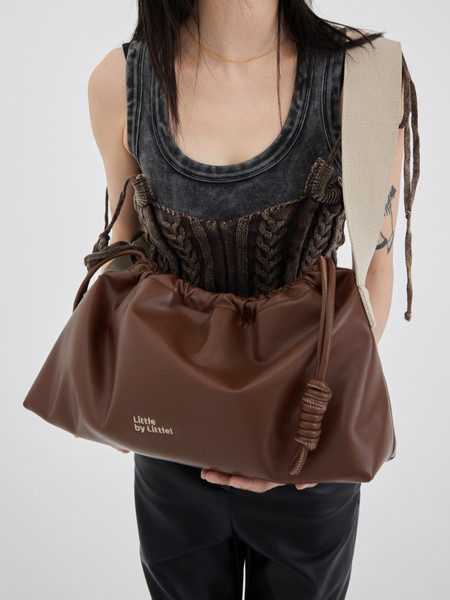 Brown oversized shoulder bag held by a model