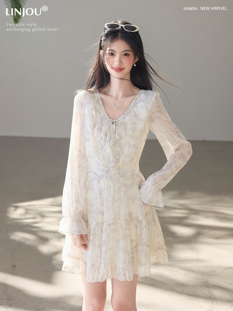 Model wearing a light floral long-sleeve dress