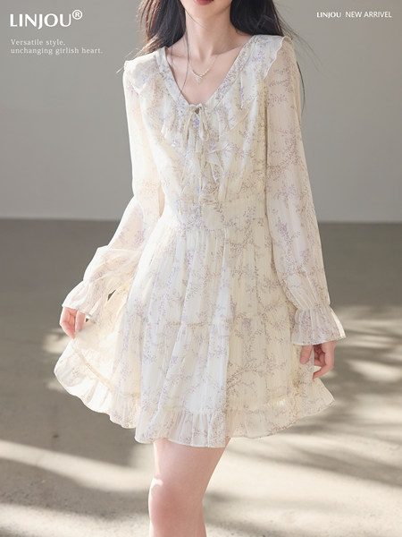Model wearing a cream floral ruffle dress