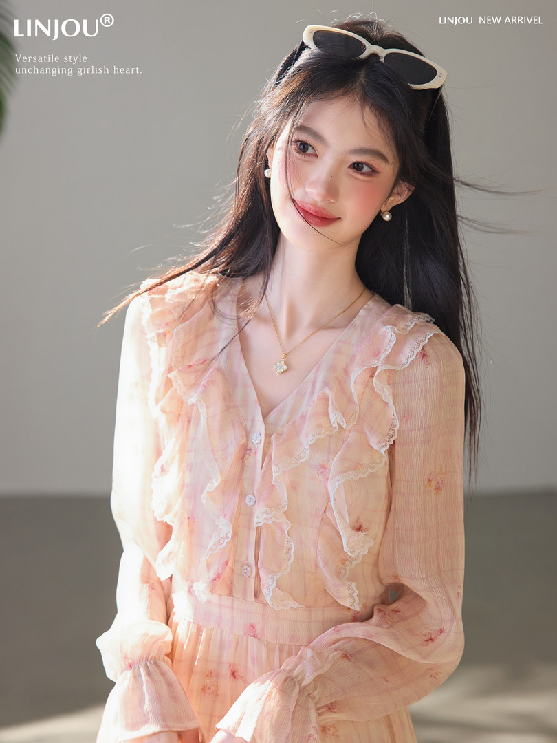 Woman modeling a peach floral ruffled dress