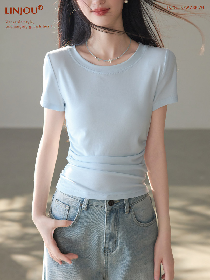 Model wearing a light blue short-sleeve fitted T-shirt with jeans