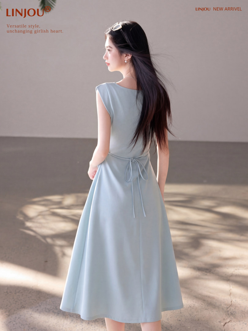 Model wearing a light blue sleeveless midi dress
