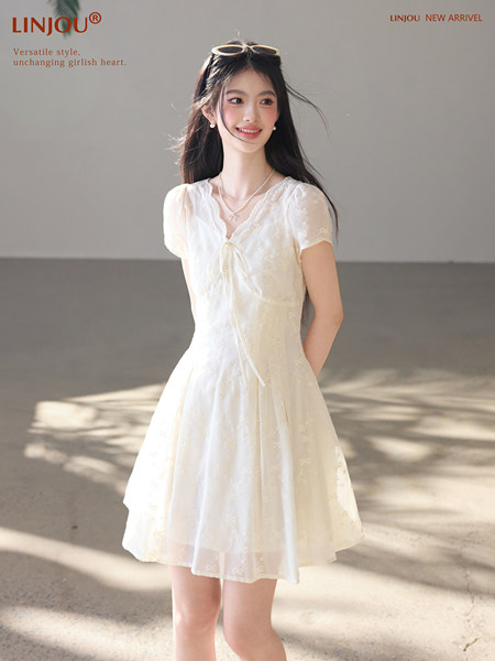 White short-sleeve floral dress worn by a model