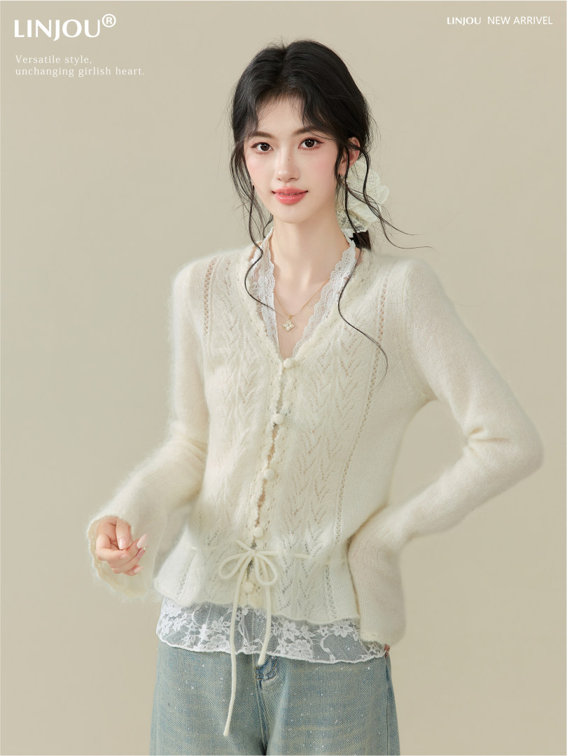 Model wearing a cream lace-trim knit cardigan and jeans