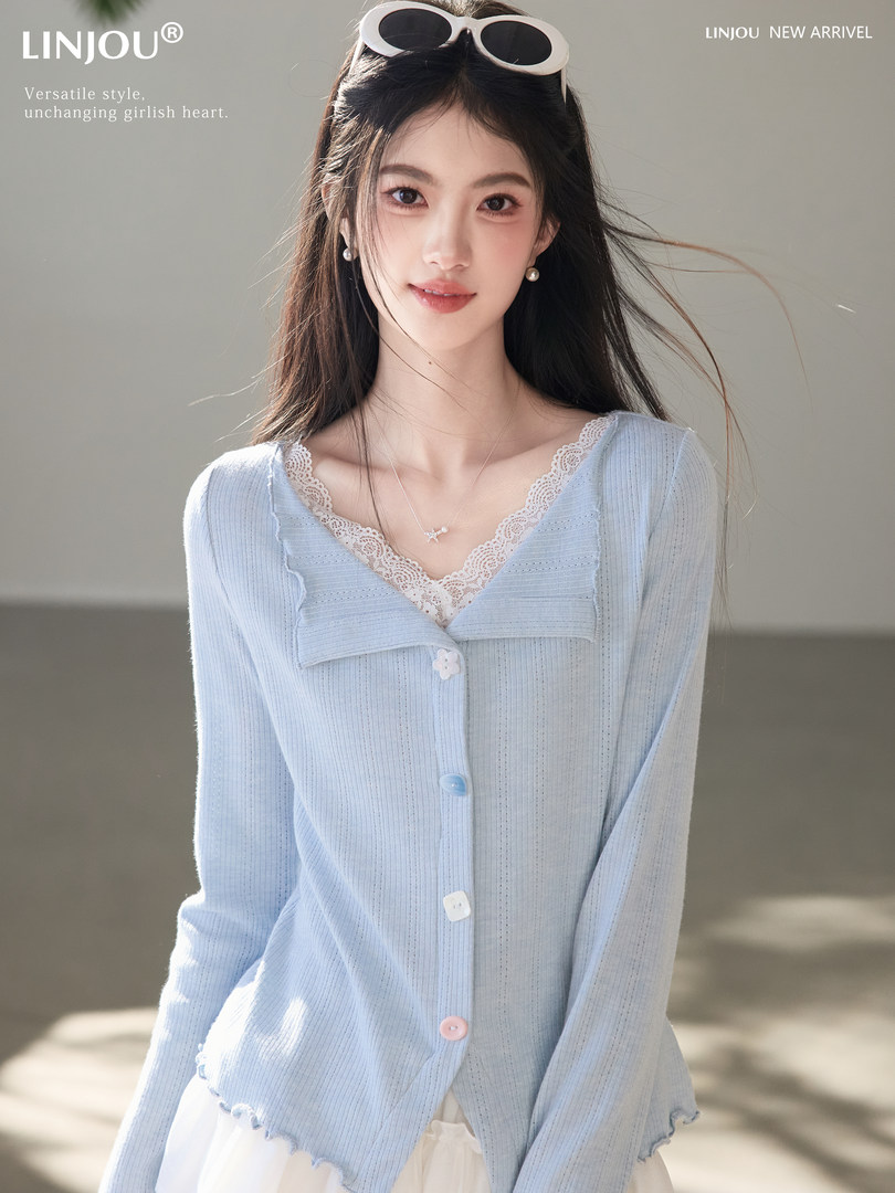 Model wearing a light blue lace-trim buttoned cardigan top