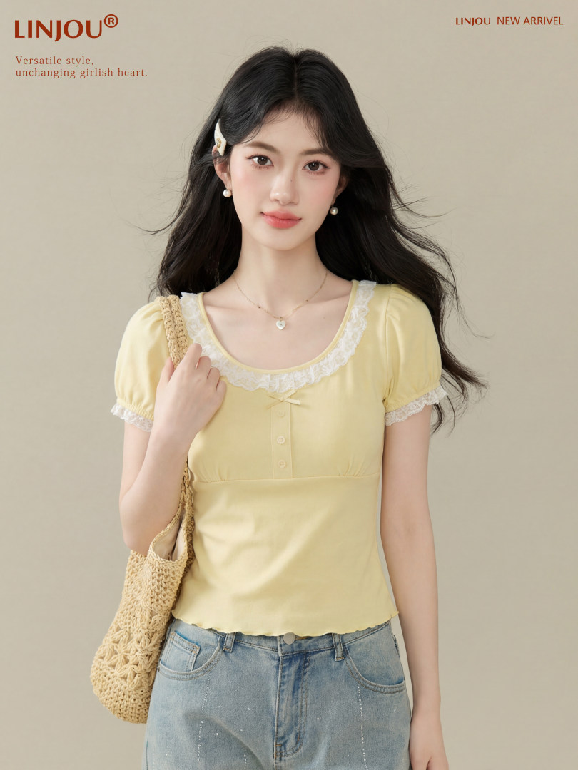 Model wearing a pale yellow lace-trim short-sleeve top with jeans and a woven bag