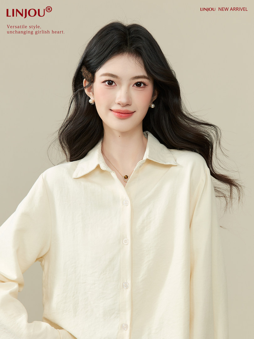 Cream long-sleeve button-up blouse worn by a model