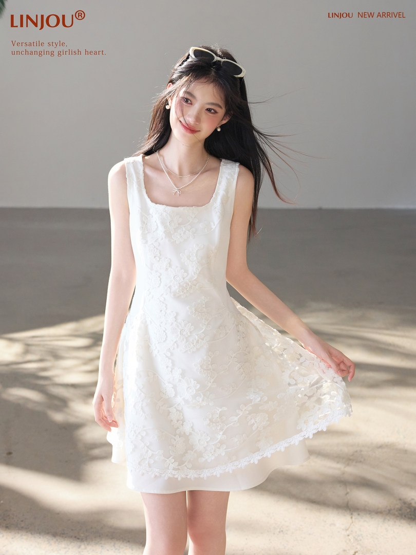 White sleeveless floral lace dress worn by a model