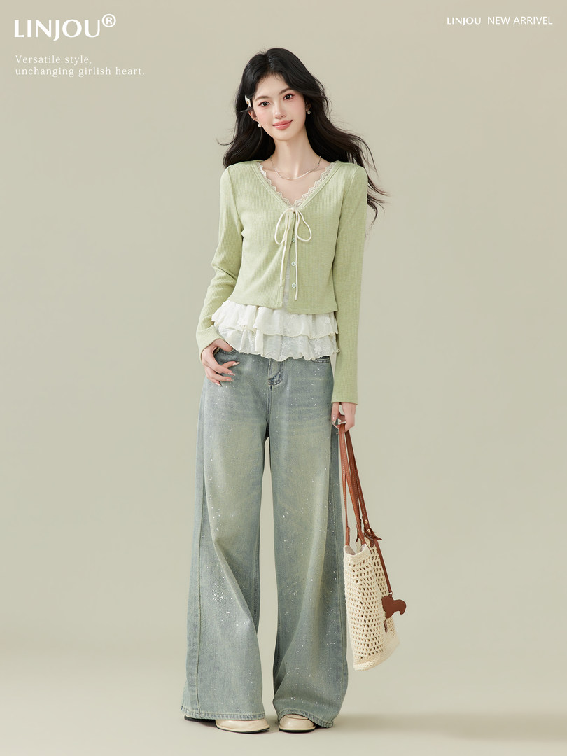 Model wearing a light green lace-trim cardigan with wide-leg jeans and a woven bag