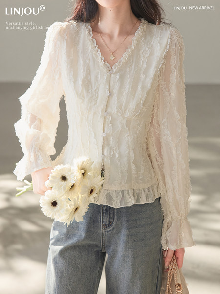 White lace long-sleeve blouse worn by a model with jeans