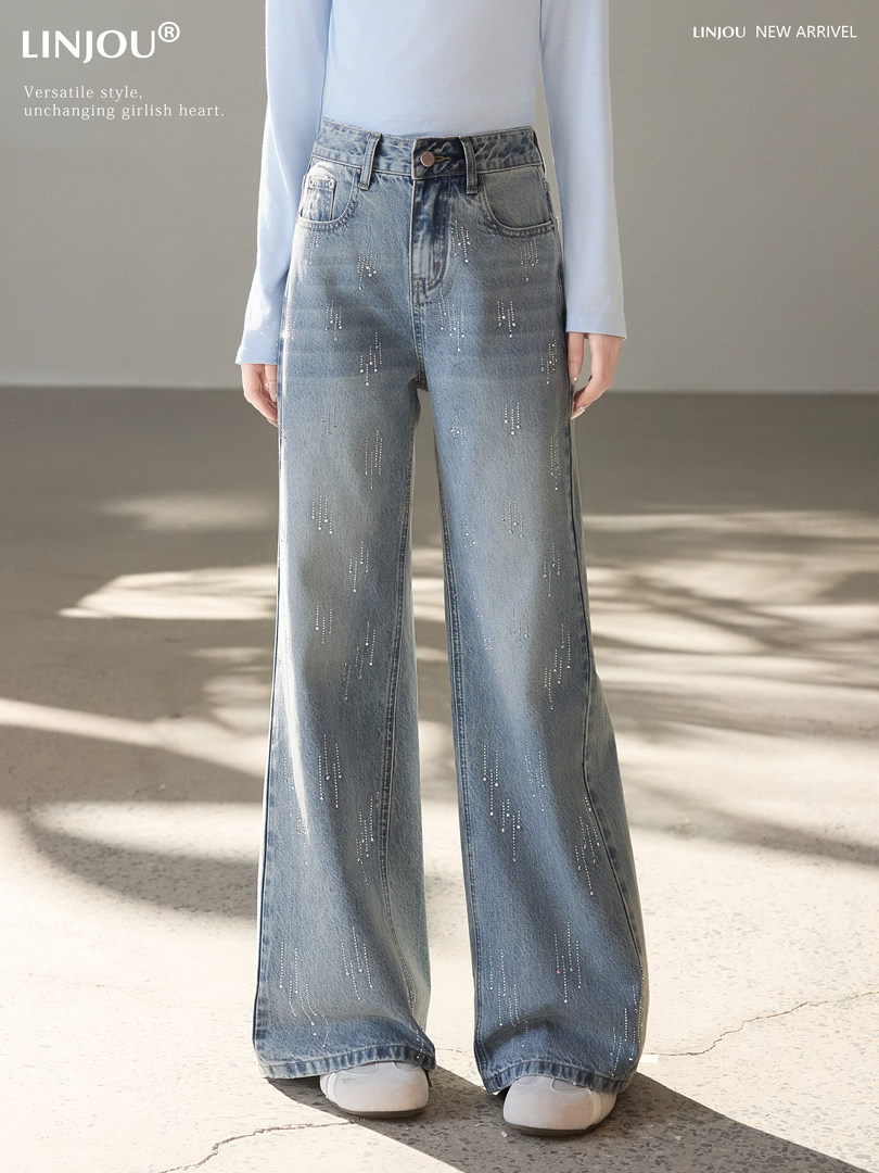 Model wearing light blue wide-leg embellished jeans