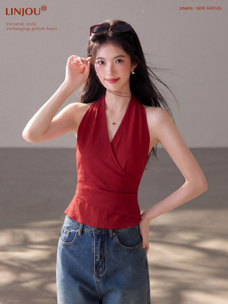 Model wearing a red halter top with a denim skirt