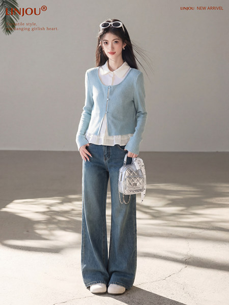 Model wearing a light blue ribbed cardigan over a white blouse with wide-leg jeans and a small silver bag