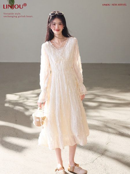 Model wearing a cream lace long-sleeve midi dress
