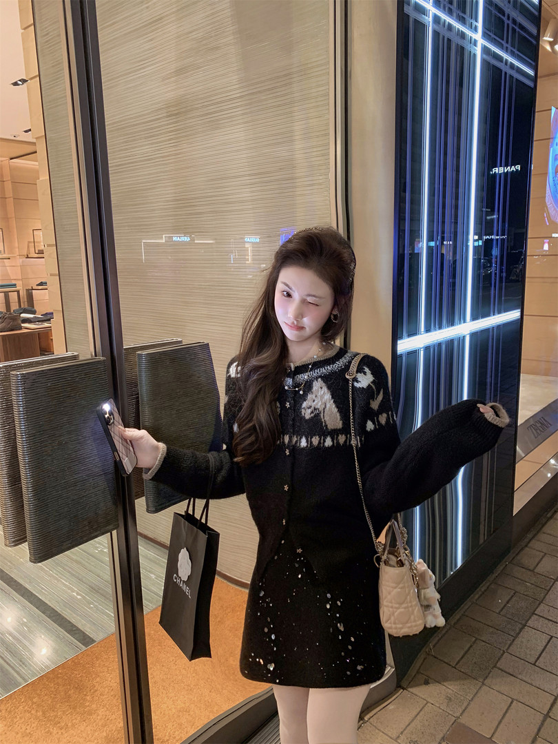 Black patterned sweater dress worn by a woman in a store