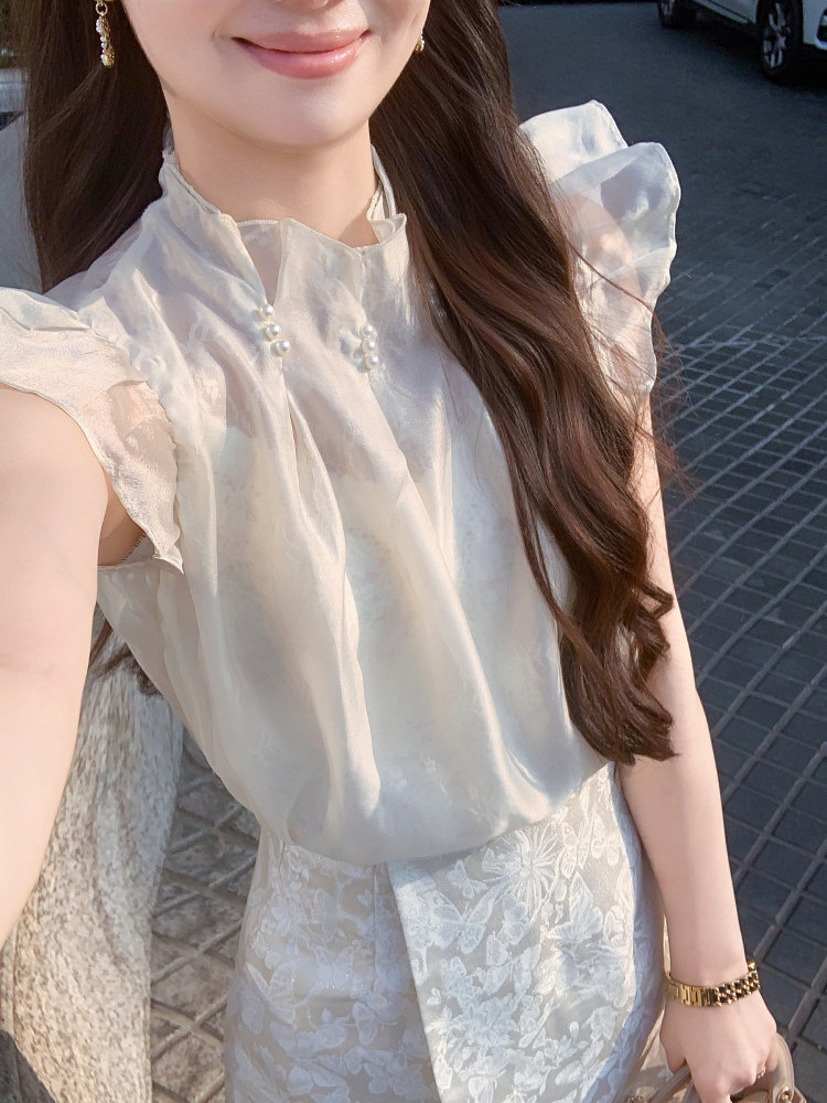 White elegant blouse and floral skirt worn by a model