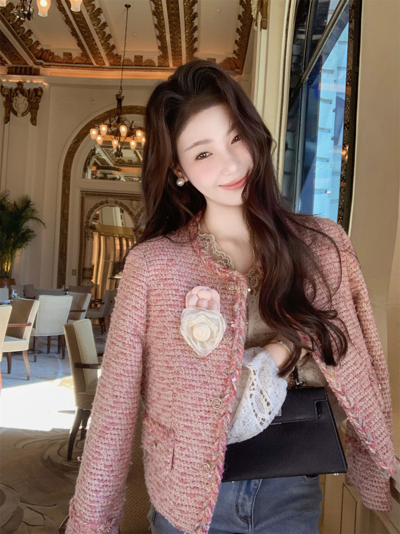 Pink tweed jacket worn by a model indoors