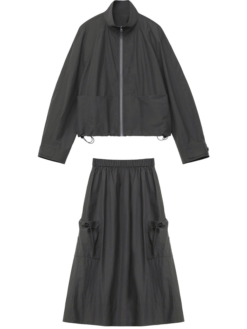 Black two-piece clothing set with zip-up jacket and long skirt laid flat on white background