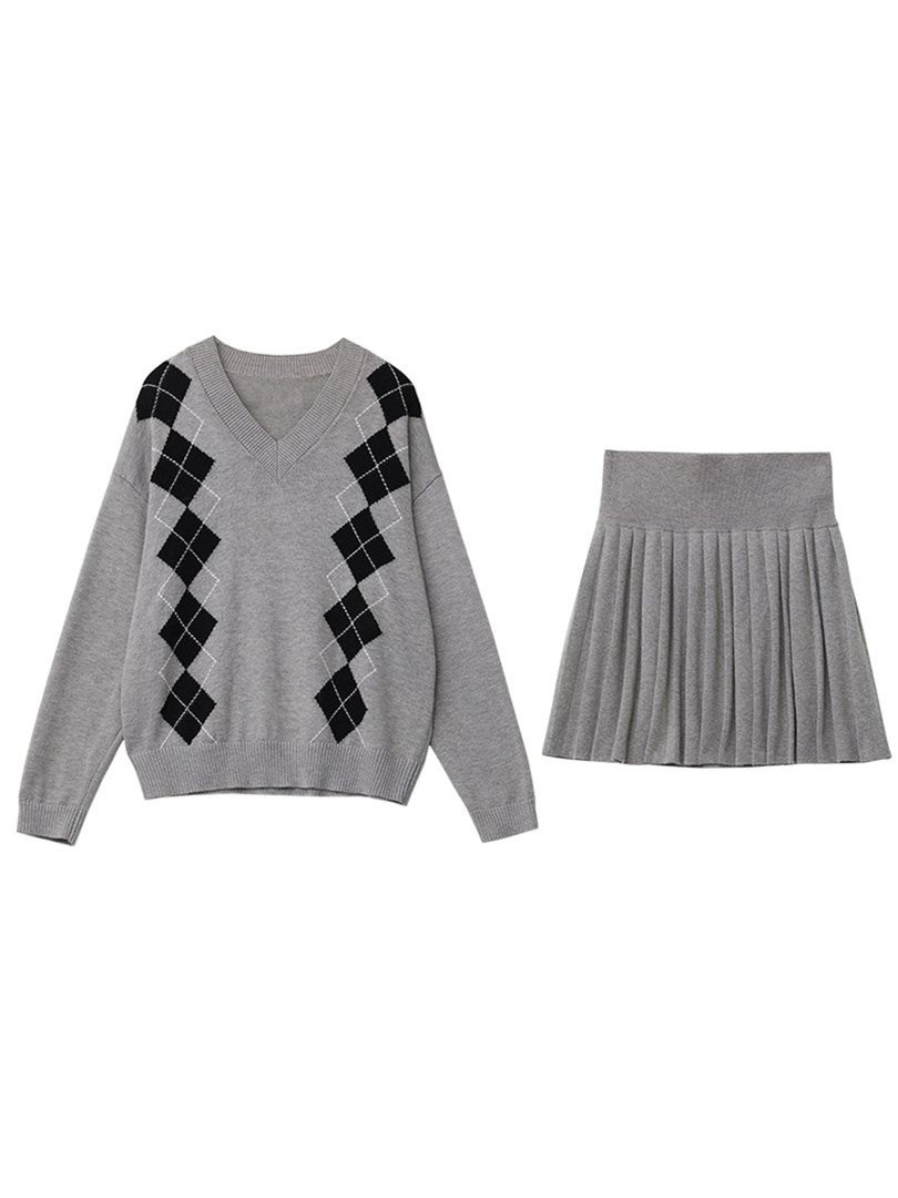 Gray argyle sweater and pleated skirt laid flat on a white background